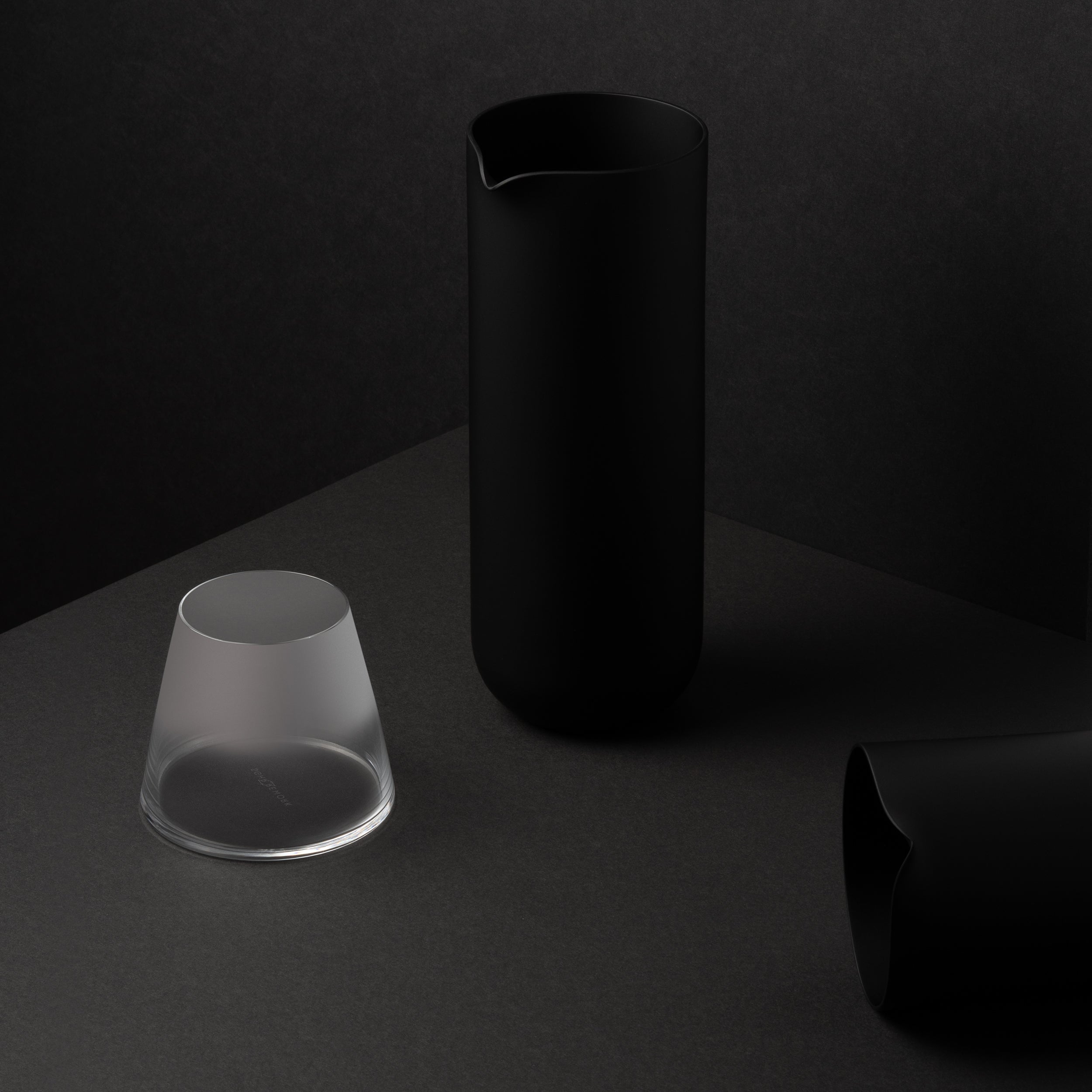 Frosted Fujiyama Glass with Sugahara Matte Black Pitcher, in a dark editorial setting.